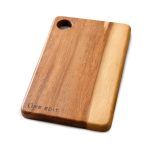 An acacia serving board featuring a natural wood finish with a circular handle and engraved branding.