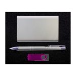 A gift set featuring a sleek power bank, a stylish pen, and a USB flash drive, all presented on a dark background.
