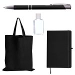 A black tote bag, black pen, sanitizer bottle, and black notebook organized in a promotional product pack.