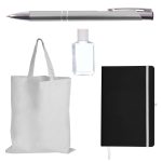 A silver pen, a clear hand sanitizer bottle, a black notebook with an elastic band, and a plain white tote bag.
