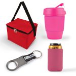 A cooler bag in red, a pink drink cup with a lid, a silver bottle opener, and a pink can cooler.