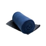 A rolled Polar Blanket in a deep blue color, positioned on a dark gray surface.