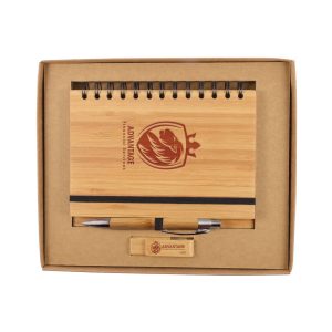 A bamboo notebook with a spiral binding, a pen, and a wooden USB drive, all presented in a cardboard gift box.