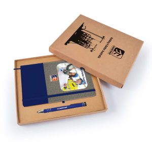 A cardboard gift set featuring a navy blue notebook and a blue pen, all in a brown box.