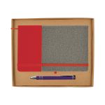 A cardboard gift set featuring a grey and red notebook with an elastic closure and a purple pen.