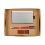A gift set including a metallic cardholder, an orange pen, and a USB flash drive, all presented in a cardboard box.