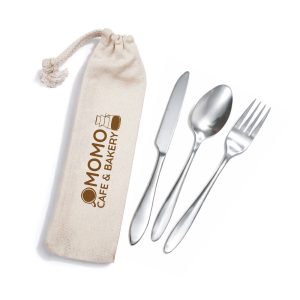A cutlery set in silver with a fork, spoon, and knife, stored in a beige calico pouch featuring a logo.