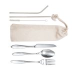 A calico pouch containing stainless steel cutlery: a knife, fork, spoon, straw, and cleaning brush.