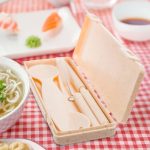 A beige ramen cutlery set in a compact case, featuring a spoon, fork, knife, and chopsticks.