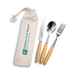 A cutlery set with stainless steel knife, fork, and spoon featuring wooden handles, packed in a fabric pouch with a logo.