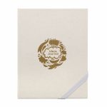 A cream-coloured journal with a gold decorative logo featuring floral designs and the words "Ideas Journal."
