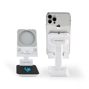 A white phone stand with a circular holder and a square base featuring a logo, supporting a smartphone.