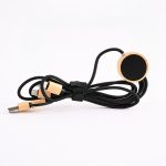A black charging cable with wooden accents, featuring multiple connectors and a circular end.