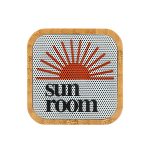 A bamboo Bluetooth speaker with a circular design featuring an orange sun graphic and 'sun room' text.