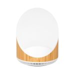A wireless speaker and charger with a bamboo base and a sleek white top, featuring a minimalistic design.