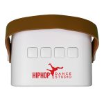 A white mini speaker with a brown strap and buttons on top, featuring a logo on the side.