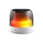 A Dazzle RGB Speaker with a glossy black and white exterior, featuring vibrant warm orange and yellow lighting.