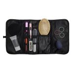 A black toiletry organizer featuring various compartments, a hairbrush, hair ties, and beauty accessories.