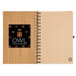 A spiral-bound A5 notebook with a bamboo cover, featuring a logo on the front and blank lined pages inside.