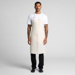 A light beige linen apron worn by a person standing against a neutral background, featuring adjustable straps and a logo.