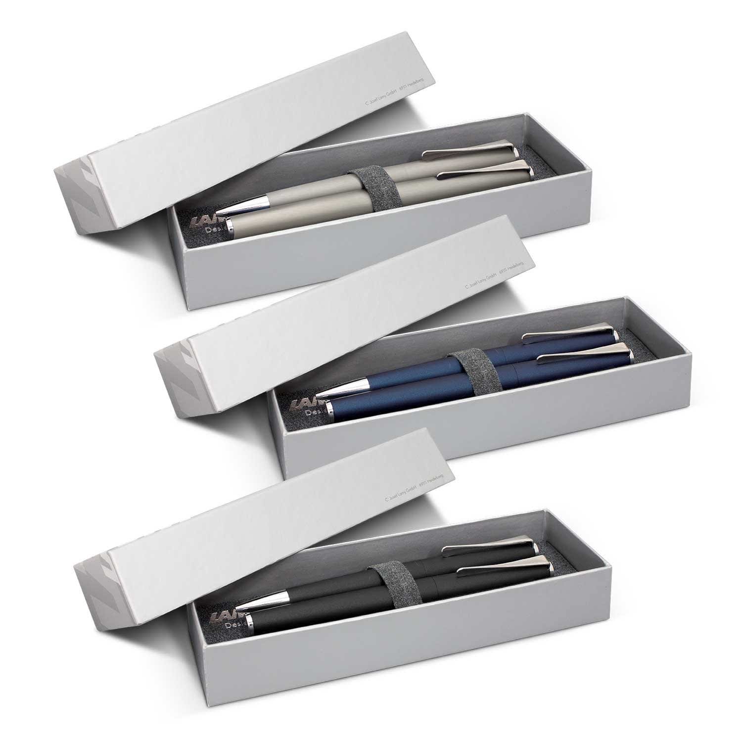 A pen set featuring three metal pens in grey, blue, and black, packaged in a sleek grey box with a logo. LAMY Studio Pen Set - Image 1