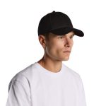 A black cap worn by a model, featuring a curved brim and a fitted design. The model is in a casual white T-shirt.