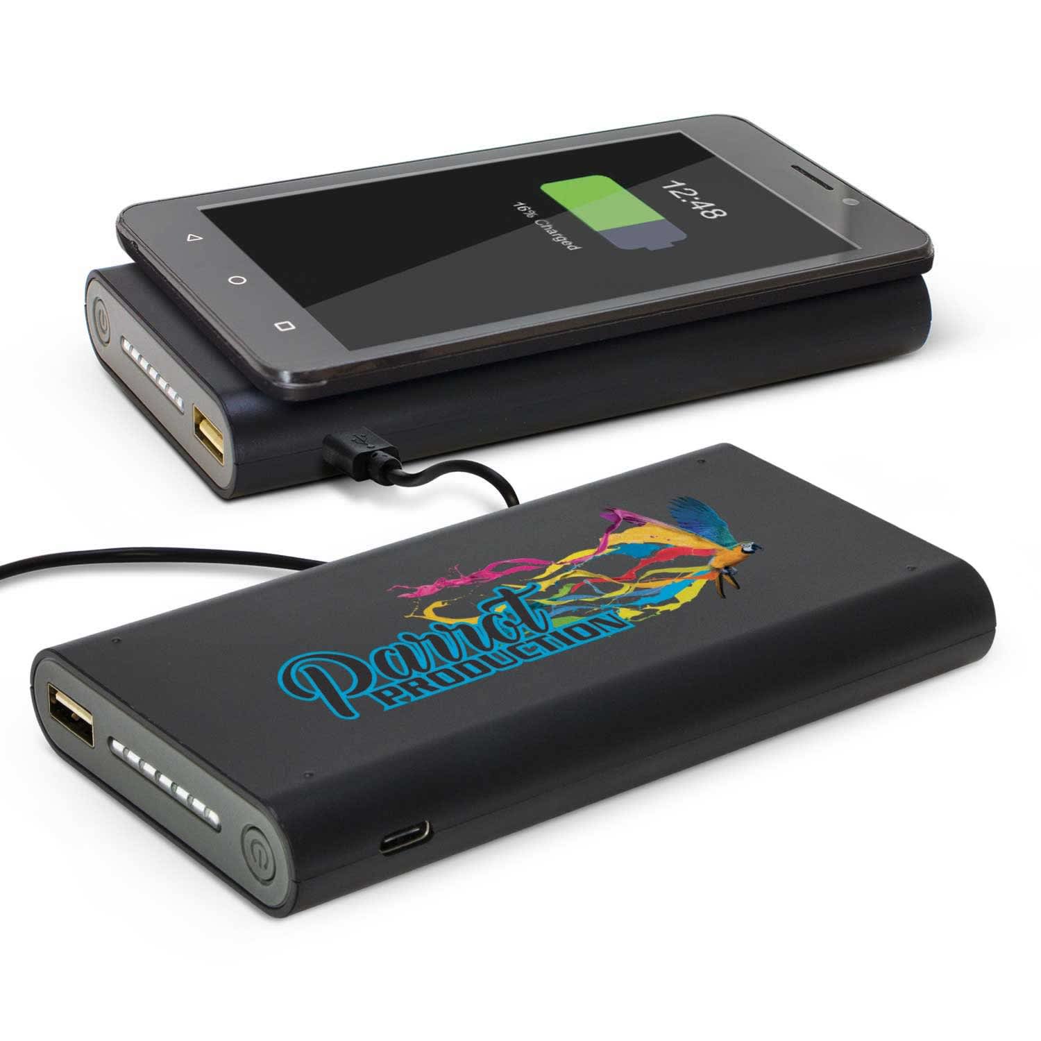 A black power bank with colourful branding, next to a smartphone displaying a charging icon. Kronos Wireless Power Bank - Image 1
