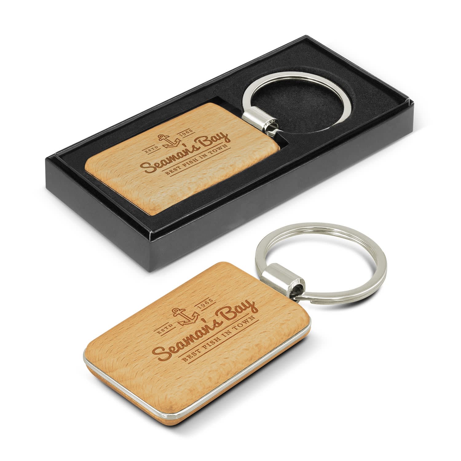 A rectangular key ring with a wooden surface and a metal keychain, presented in a black box. Echo Key Ring - Rectangle - Image 1