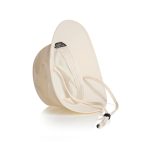 A cream nylon wide brim bucket hat featuring an adjustable chin strap and an inner lining. It has a logo on the inside.