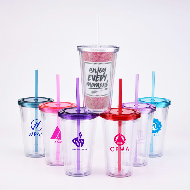 A collection of clear plastic cups with colourful lids and straws, featuring various logos. 16oz Plastic Cups with Lids & Straws - Image 1