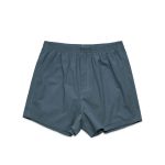 A pair of grey boxer shorts with an elastic waistband and loose fit, featuring a plain design.