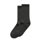 Two pairs of dark grey socks, featuring a simple ribbed design, laid flat against a white background.