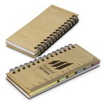 A bamboo sticky note wallet featuring a spiral binding, containing sticky notes in various pastel colours and a ruler design.