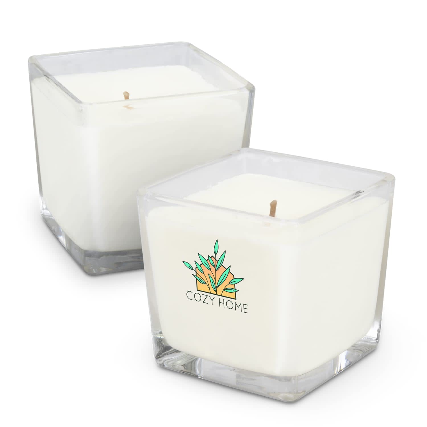 A square, white scented candle in a clear glass container, featuring a logo design. Two candles are shown. Ambient Scented Candle - Image 1