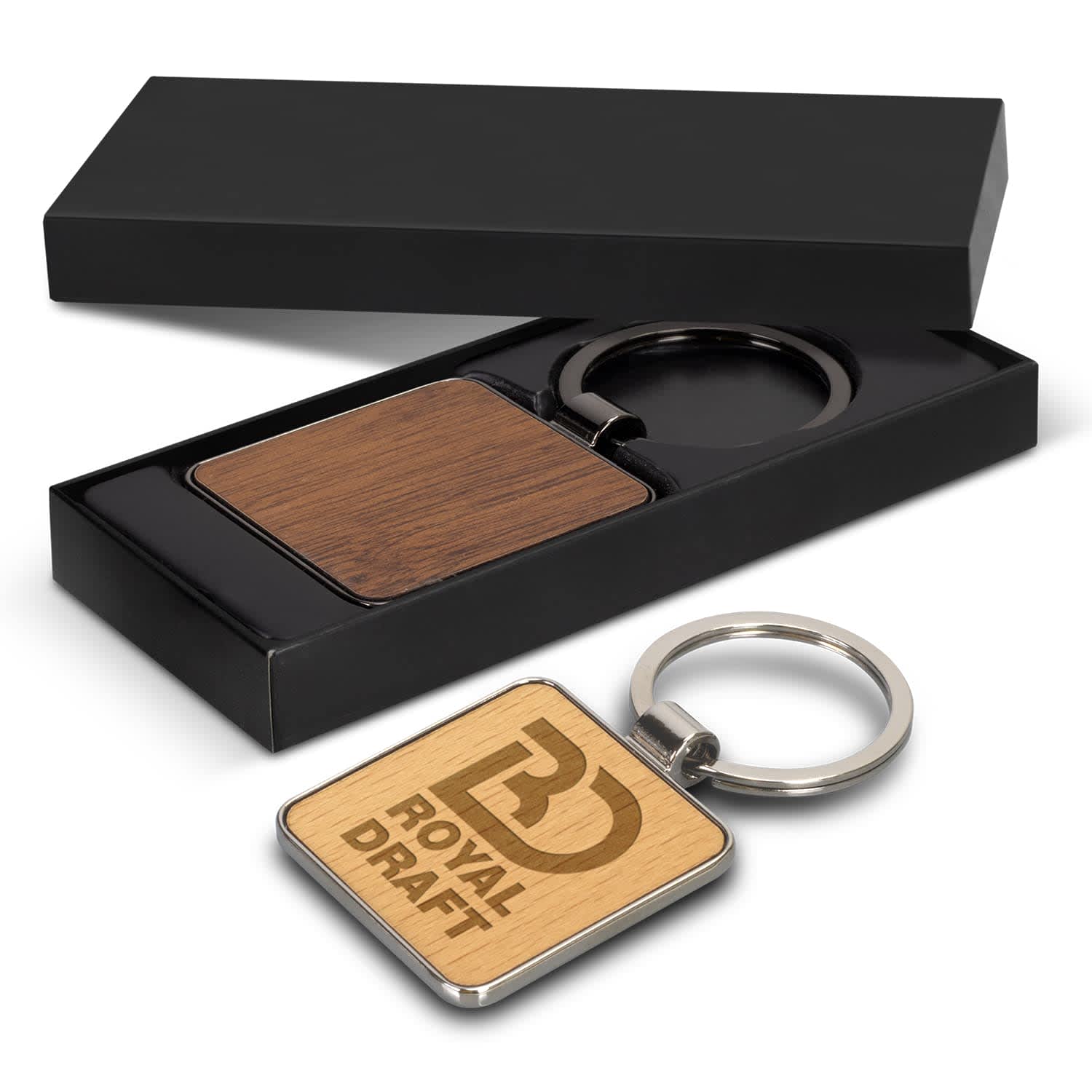 A square wooden key ring with a metal keychain, displayed in a black gift box. Santo Key Ring - Square - Image 1