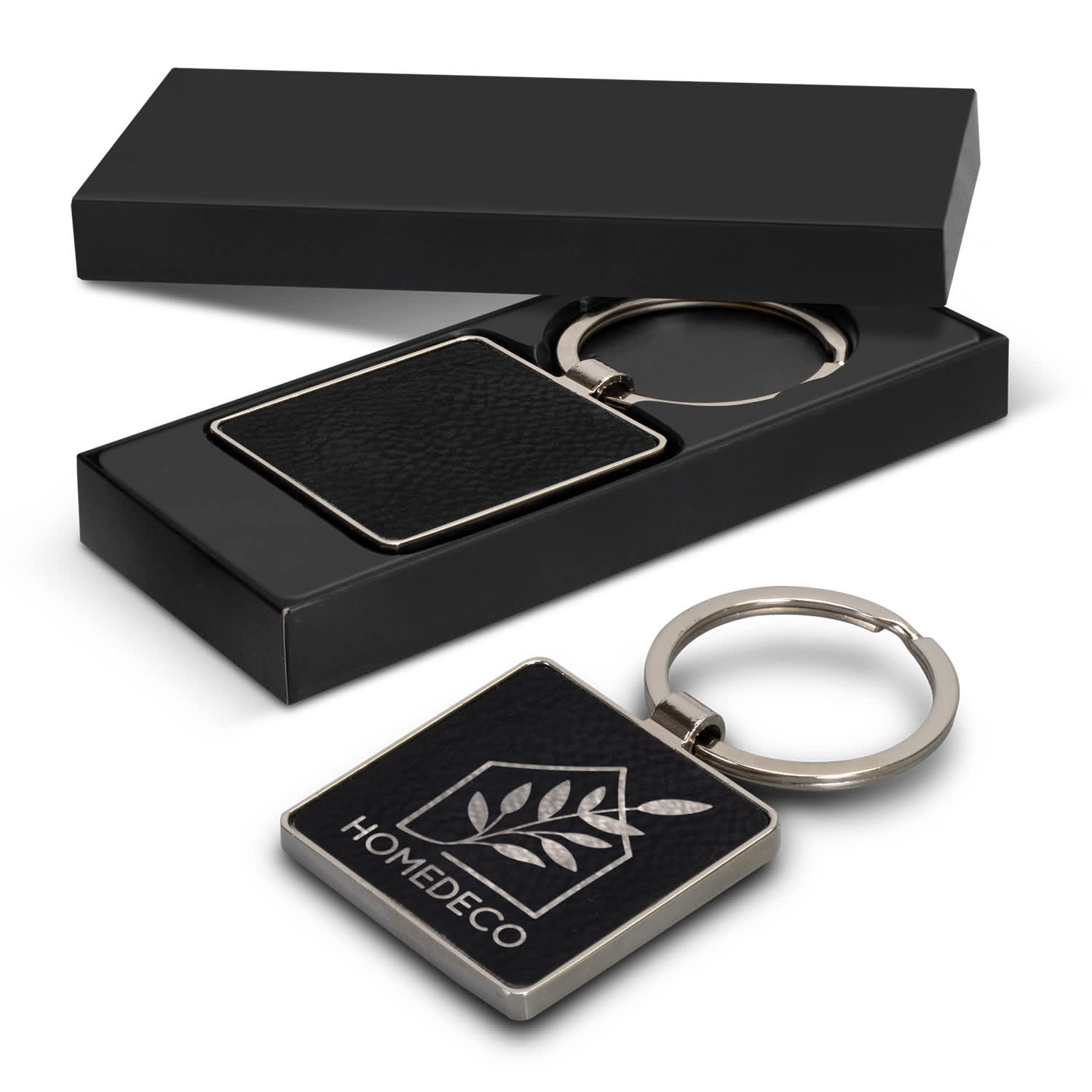 A square key ring with a leather-like texture, presented in a black box with a logo. Capulet Key Ring - Square - Image 1