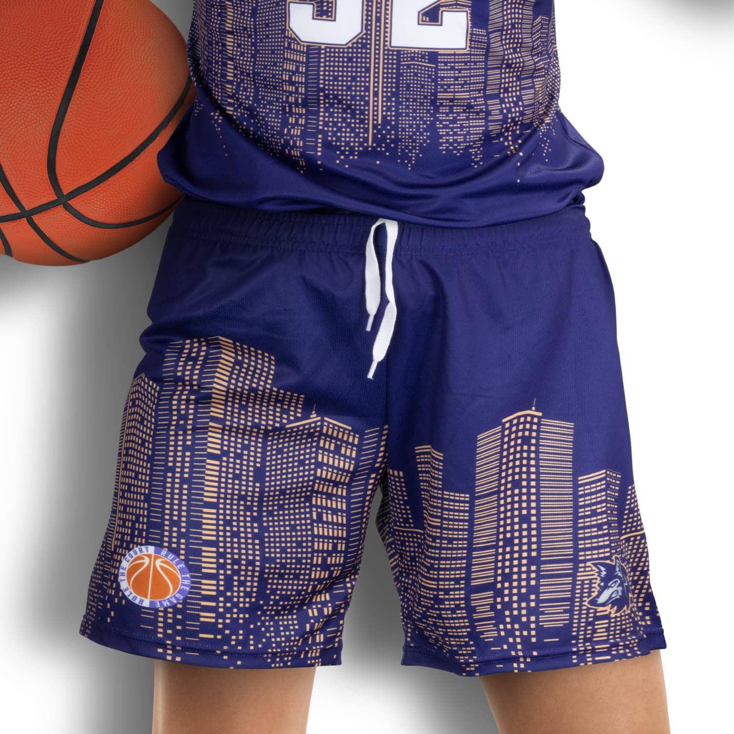 Custom women's basketball shorts in navy blue featuring a city skyline design and a basketball logo. Custom Womens Basketball Shorts - Image 1