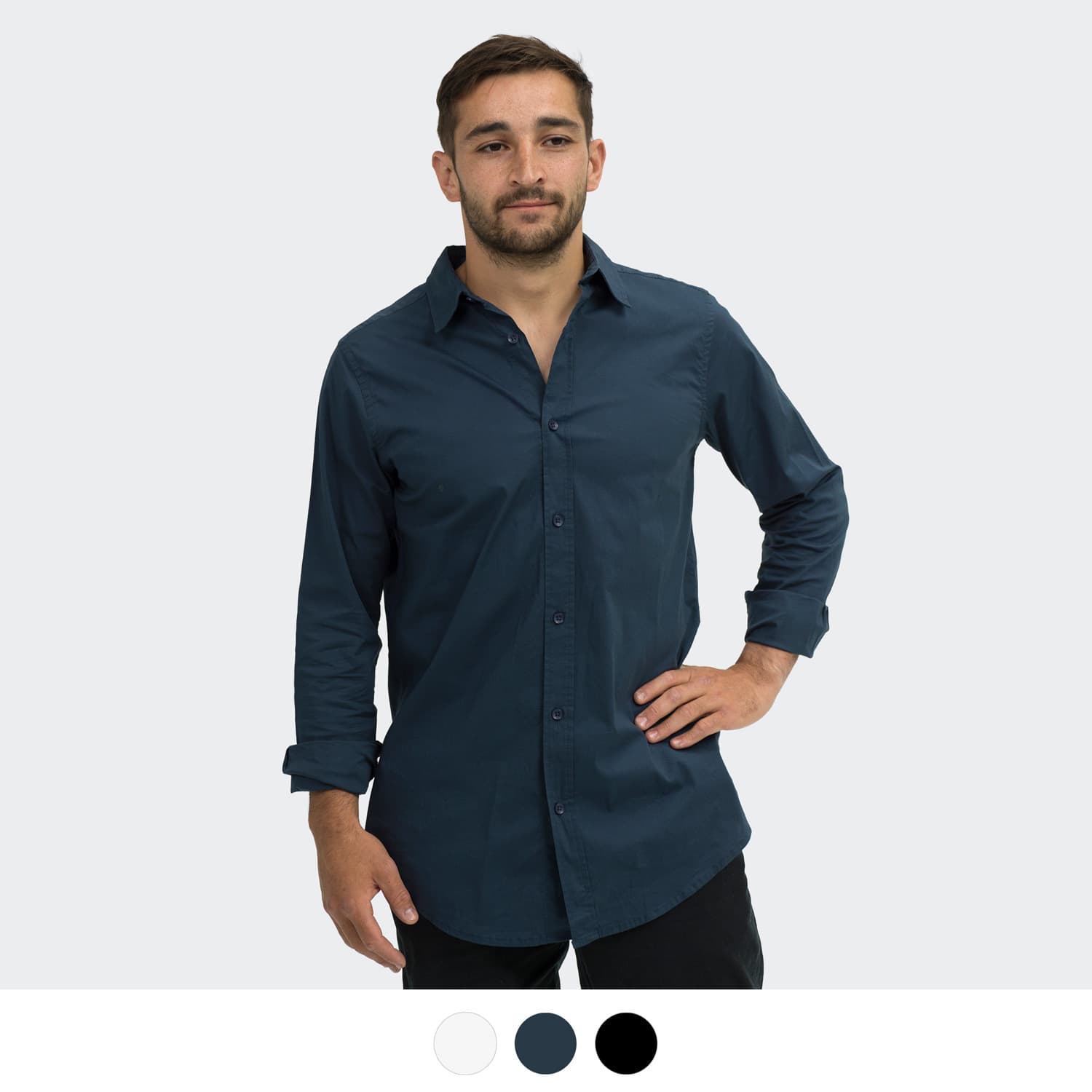 A man stands in a dark navy button-up shirt with long sleeves. The shirt features a logo on the chest. TRENDSWEAR Parker Men's Poplin Shirt - Image 1