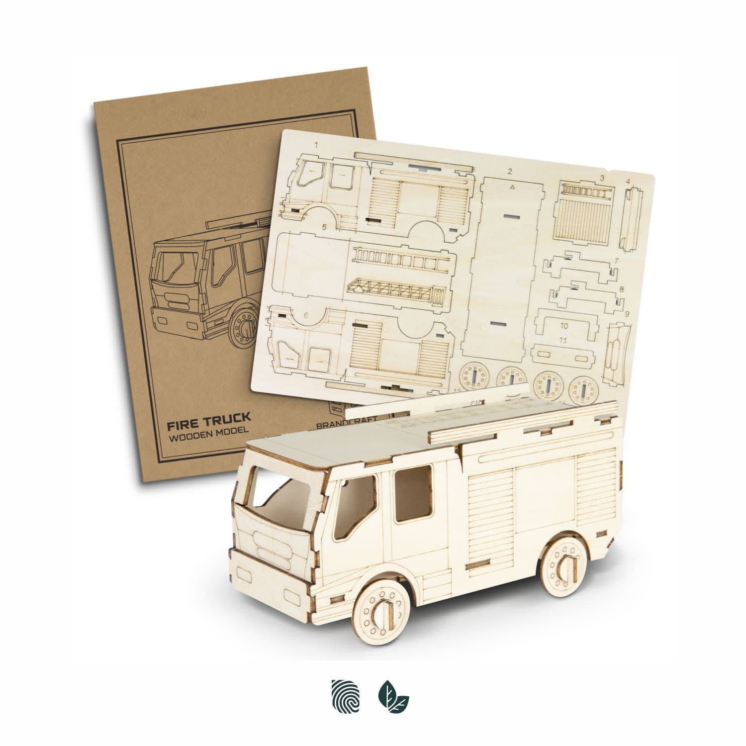 A wooden model of a fire truck in natural wood colour, accompanied by assembly instructions. BRANDCRAFT Fire Truck Wooden Model - Image 1