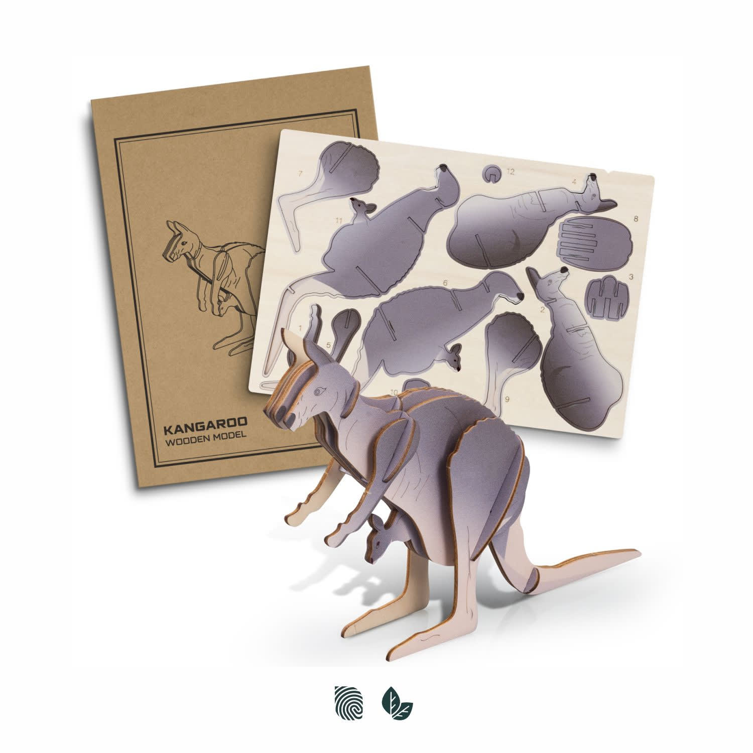 A wooden model of a kangaroo in natural wood tones, next to a craft sheet with assembly pieces and instructions. BRANDCRAFT Kangaroo Wooden Model - Image 1