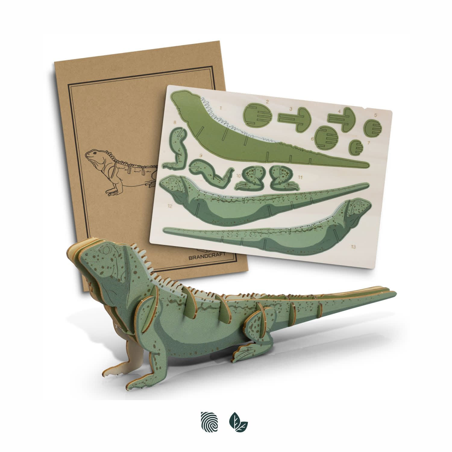 A green tuatara wooden model partially assembled, with detailed assembly instructions displayed beside it. BRANDCRAFT Tuatara Wooden Model - Image 1