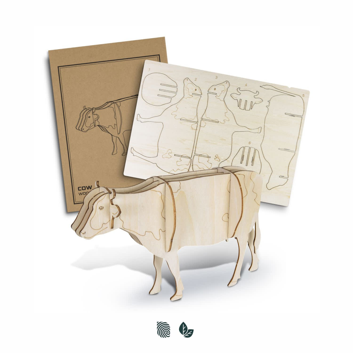 A wooden model of a cow in natural wood finish, alongside laser-cut components for assembly. Includes a branded packaging. BRANDCRAFT Cow Wooden Model - Image 1