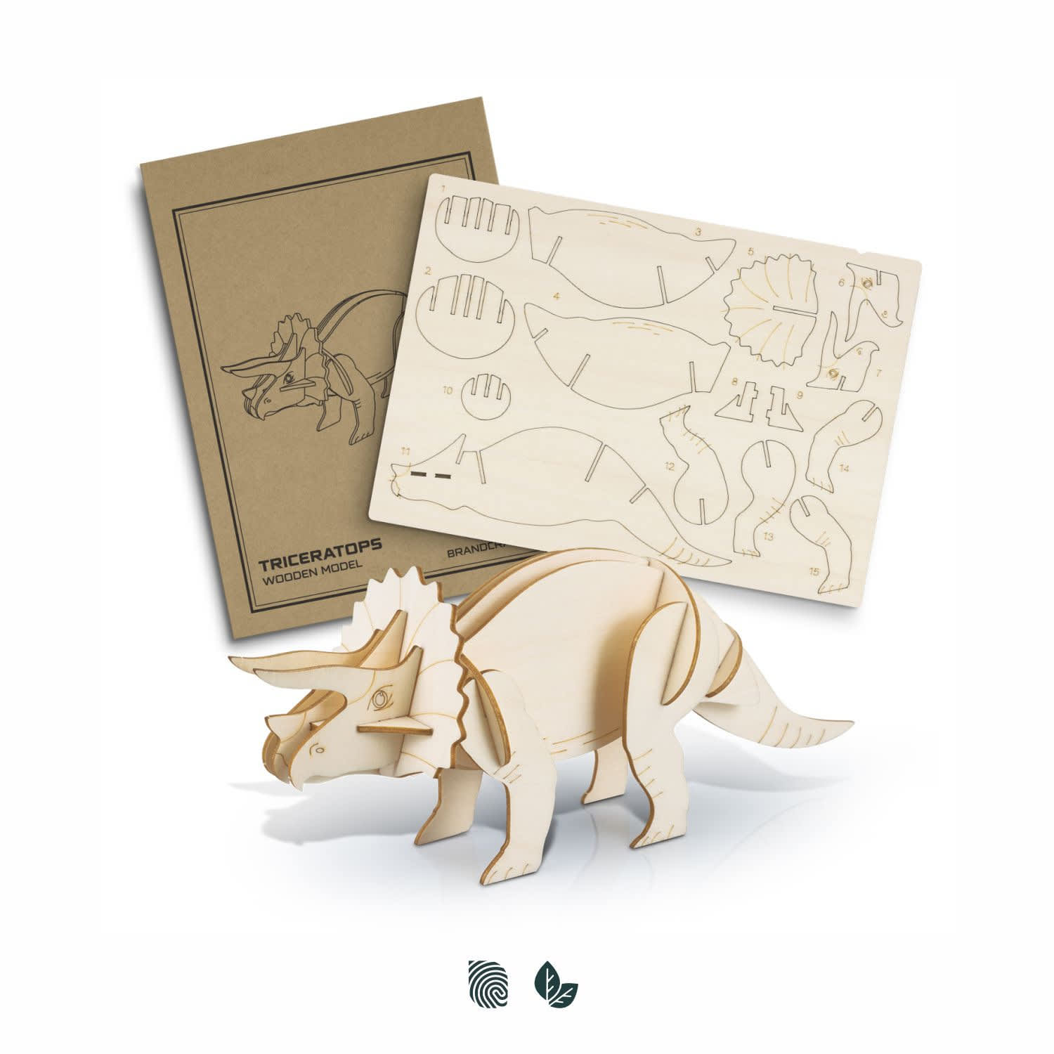 A wooden model of a triceratops in natural wood colour, alongside its parts sheet and packaging with a logo. BRANDCRAFT Triceratops Wooden Model - Image 1