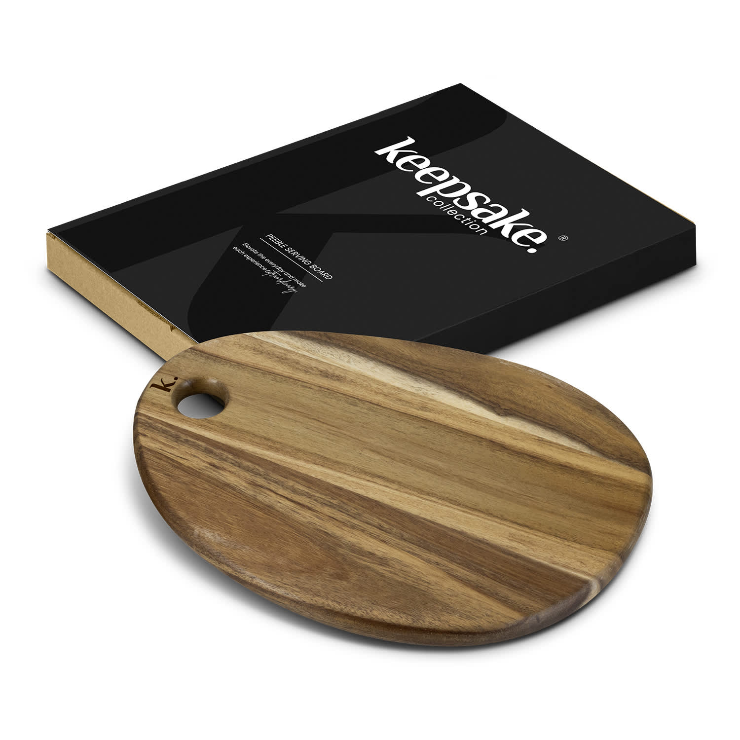 A wooden oval serving board in natural tones beside a black box with a logo. Keepsake Pebble Serving Board - Image 1