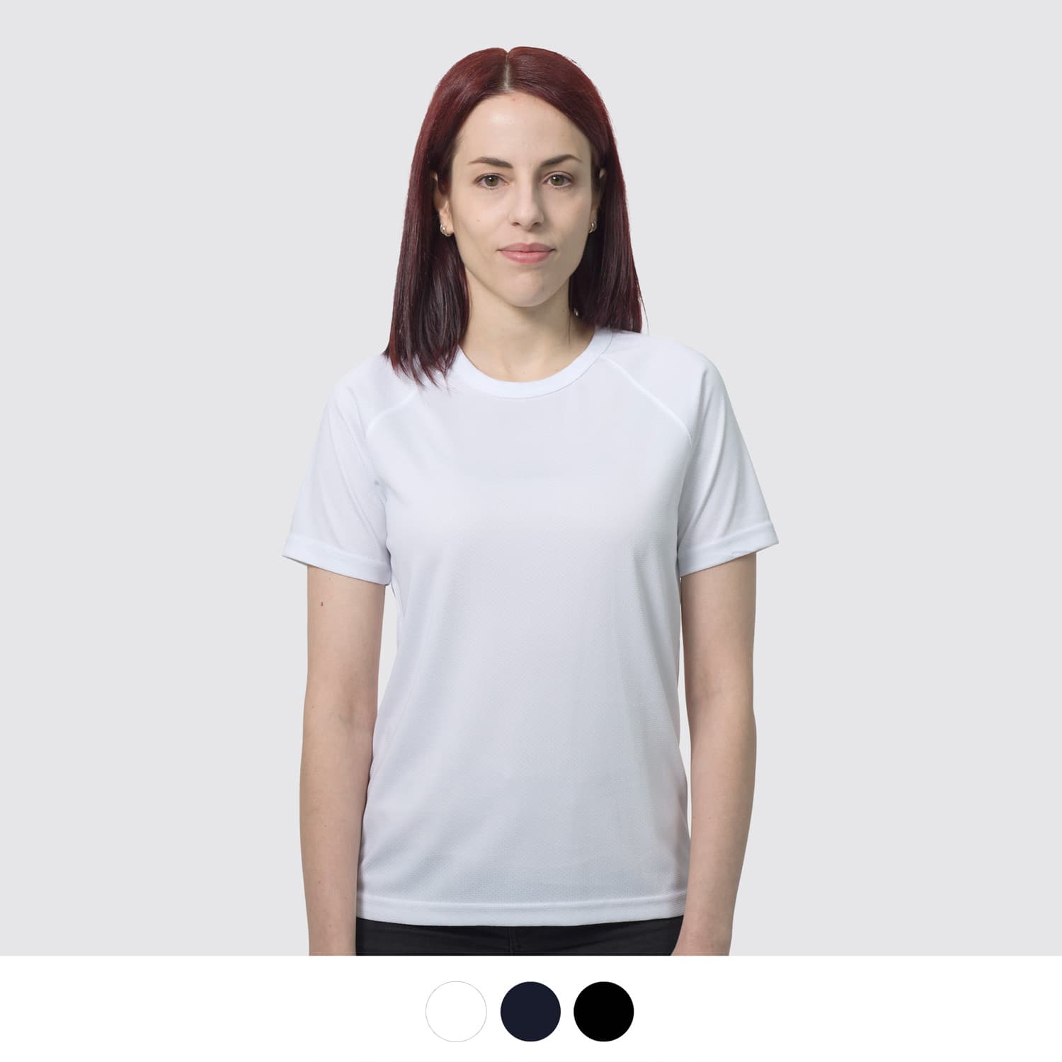 A white women's sports T-shirt with a round neck, featuring a logo, displayed on a model against a light background. TRENDSWEAR Agility Womens Sports T-Shirt - Image 1