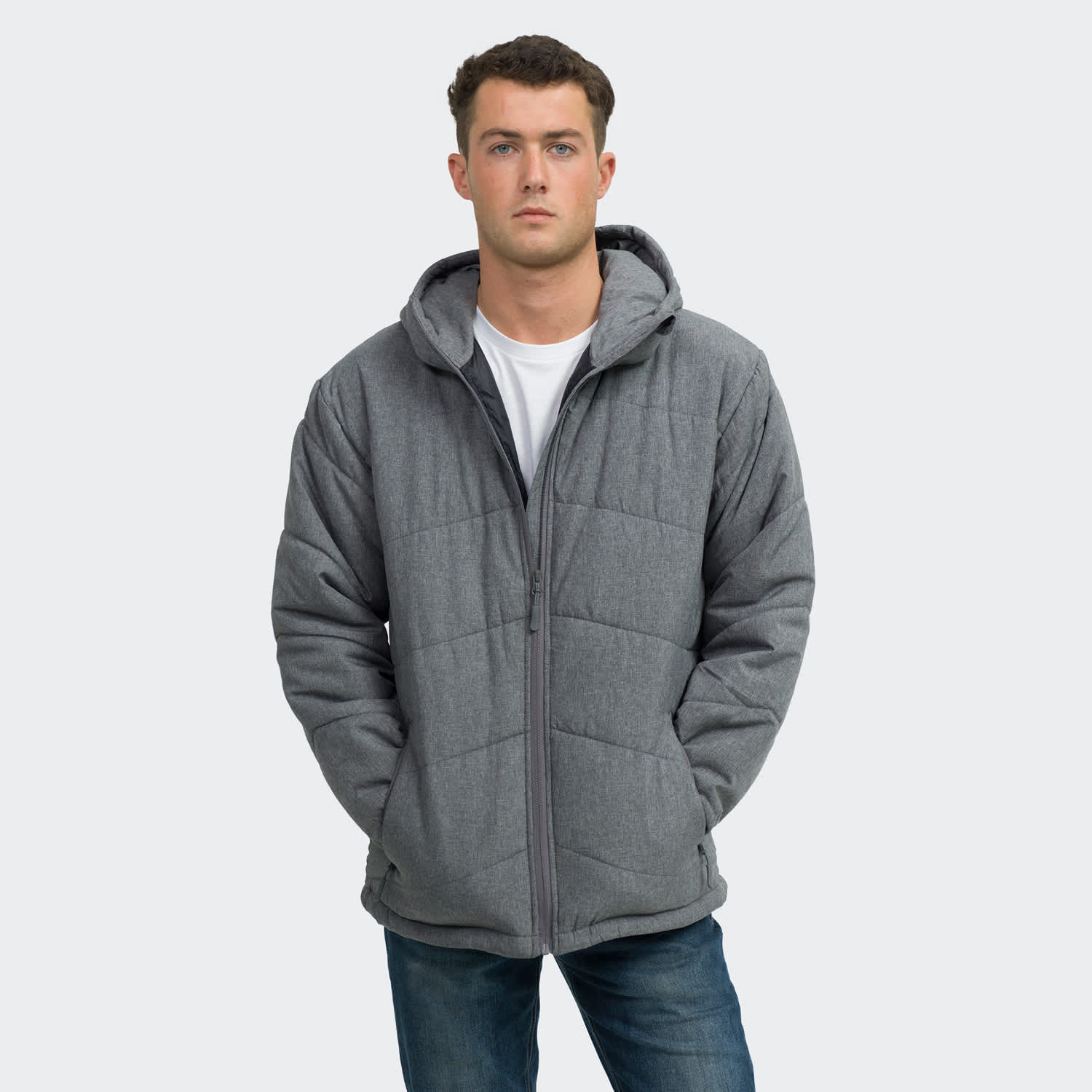 A men's puffer jacket in grey, featuring a hood and a zip-up front, worn by a model. TRENDSWEAR Newport Mens Puffer Jacket - Image 1