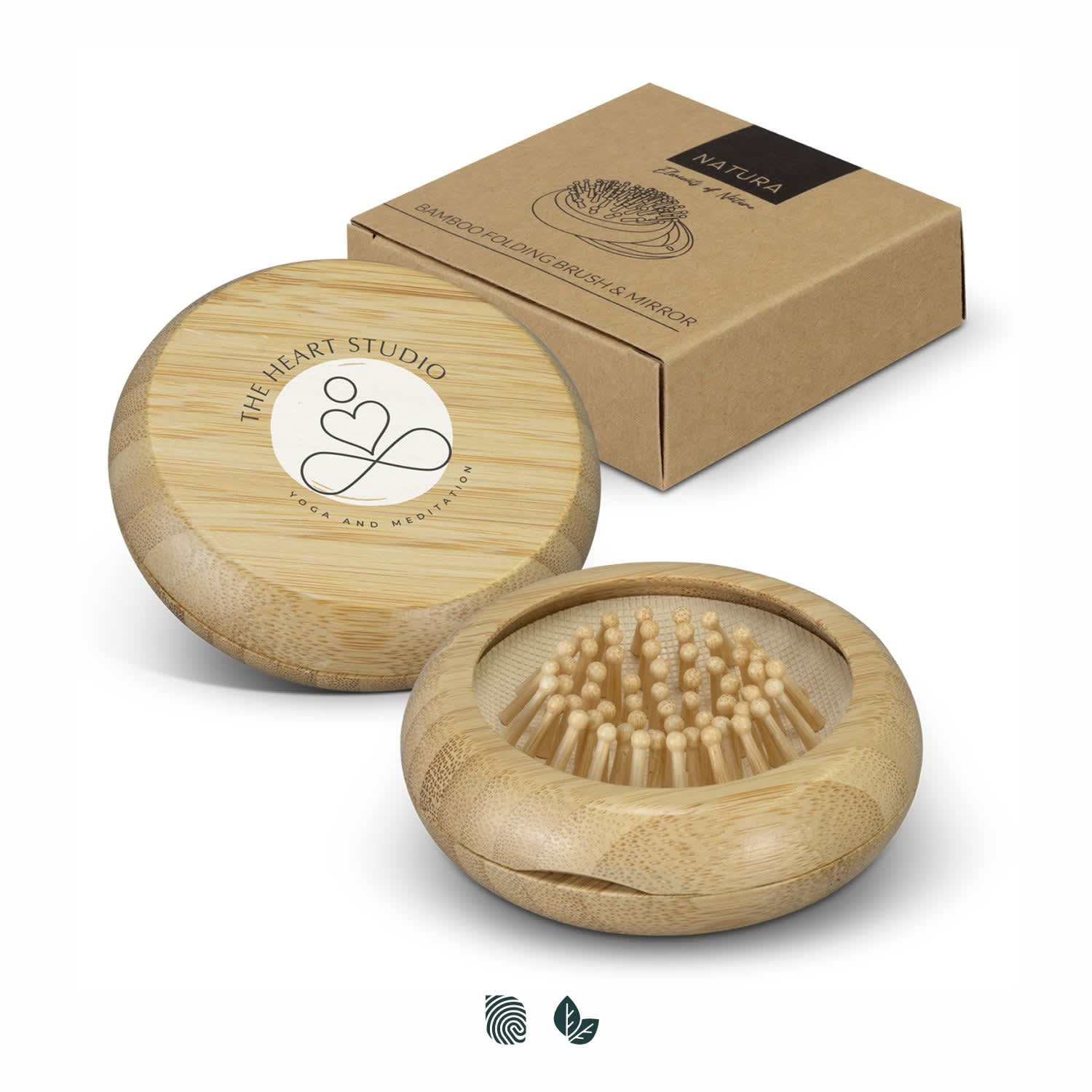 A bamboo brush and mirror set in a circular case, accompanied by a cardboard box. The brush features wooden bristles. NATURA Bamboo Brush and Mirror - Image 1
