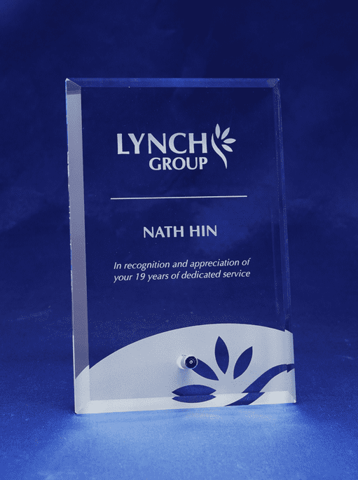 A clear glass rectangle award with laser engraving, featuring a logo and floral design. تسهيلات. Clear Glass Rectangle - Laser Engraved - Image 1
