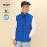 A blue soft shell vest with a zip front and side pockets, featuring a logo on the chest.