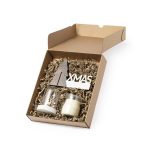 A gift box featuring a candle, a decorative piece shaped like a tree, and shredded paper filling, all in a natural cardboard box.